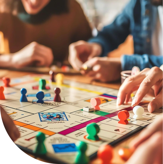 A group of people is enthusiastically playing a colorful board game and moving pieces across the board. The setting is cozy and radiates joy and interaction.